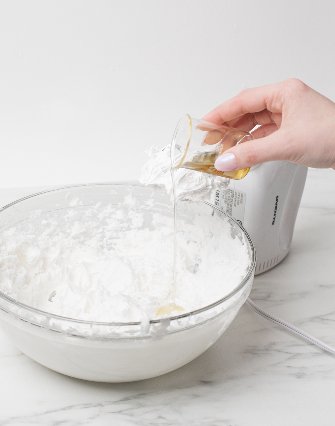 Pouring essential oil into whipped soap.